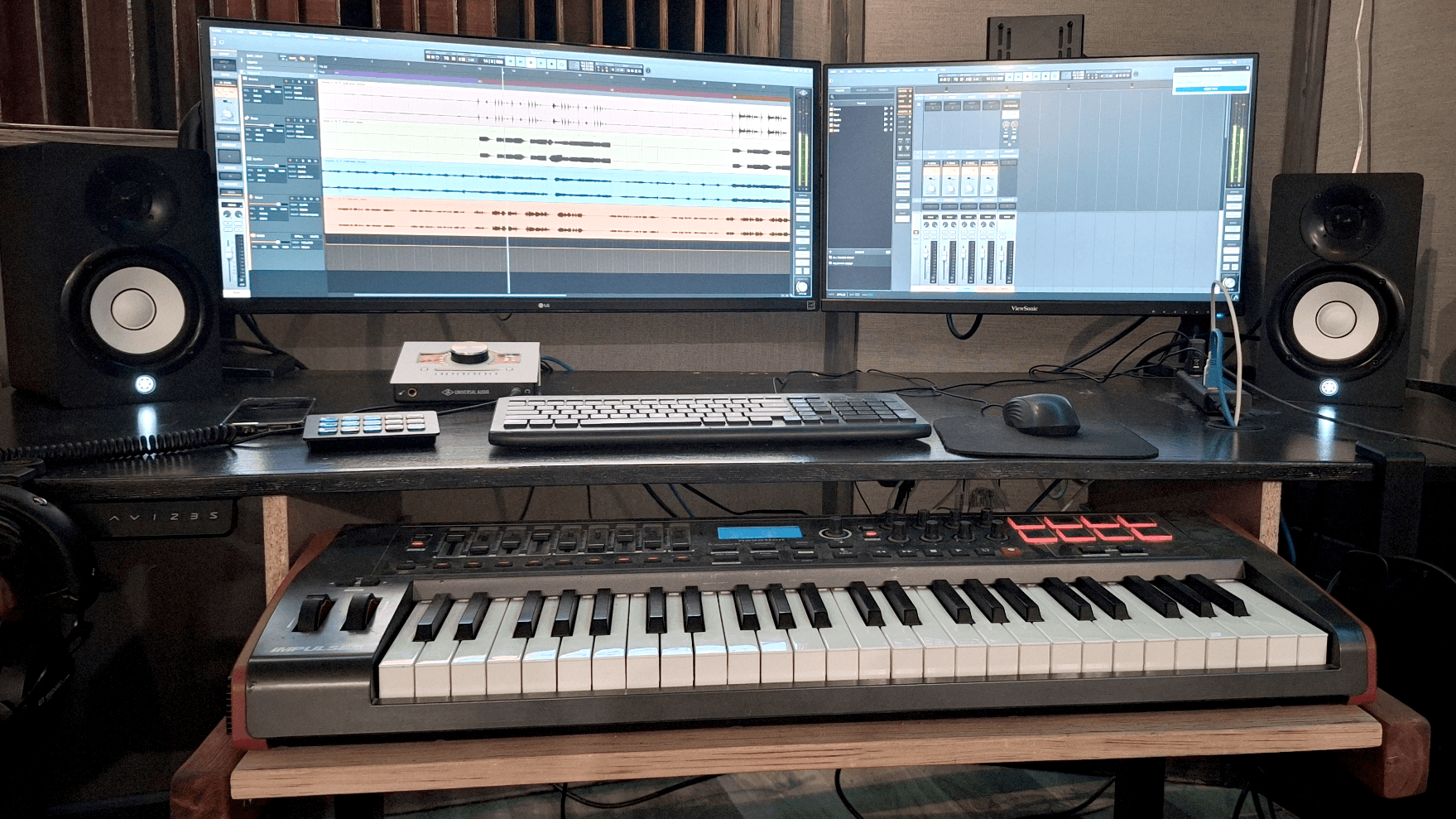 Quiet, relaxed writing and production corner with dual monitors, sofa, organ, and bookshelf