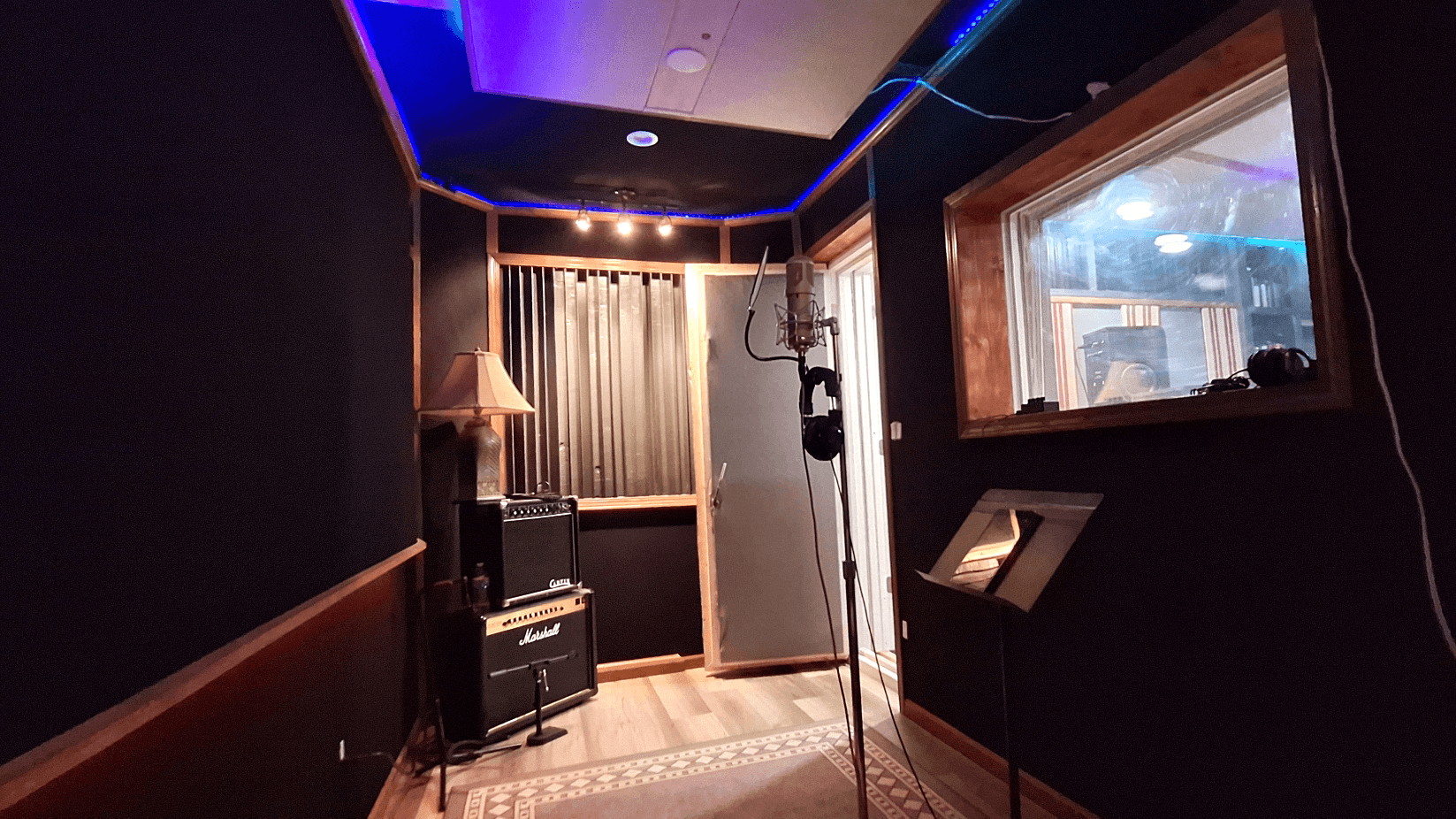 Vocal room and live room with acoustic treatment, instruments, and a comfortable performance layout